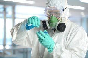 Scientist in protective clothing working in laboratory